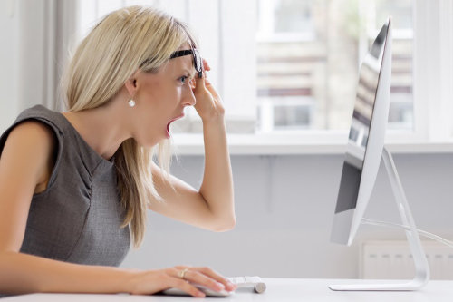 Shocked woman reading emails