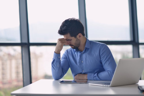 Anxious businessman worrying over his bad business website