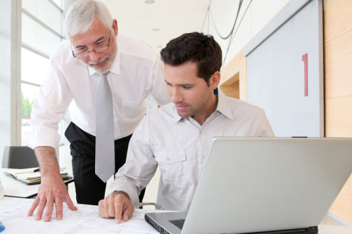 Older employee shows leader how to do it