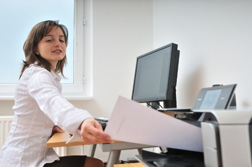 Businesswoman printing documents