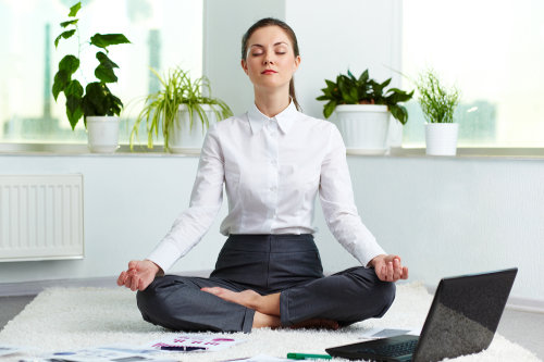 Meditating business woman