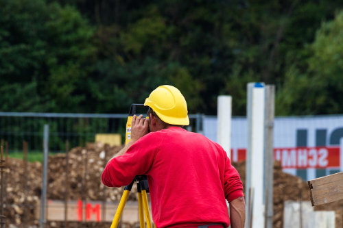 Surveying construction worker