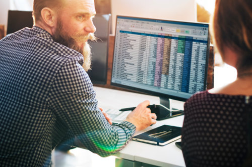 Business people using financial software