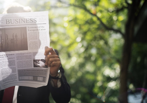 Small business owner reading newspaper