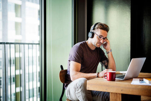 Businessman listening to music via headphone