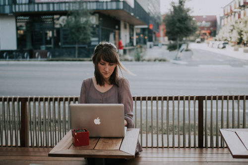 Productive businesswoman works in a cafe