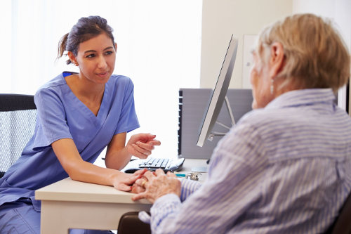Healthcare worker consulting with patient