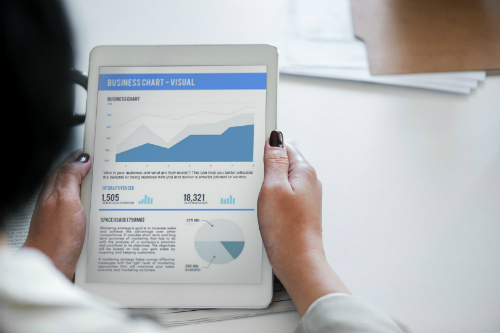 Entrepreneur reading stocks on tablet