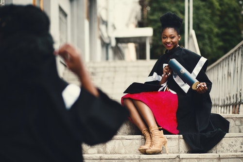 Woman taking picture after graduating with master's degree