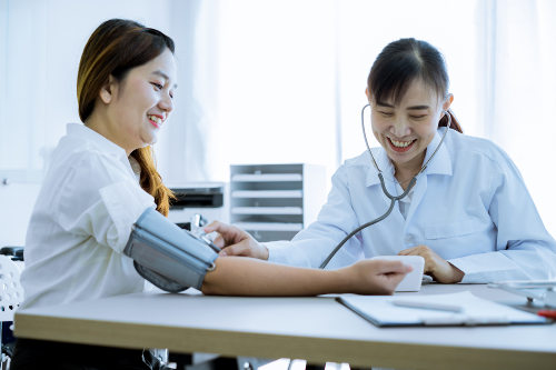 doctor checking patient's blood pressure