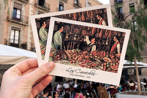 Holding vintage postcards