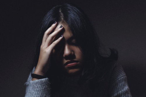 Stressed out woman due to debt mistakes