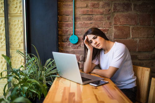 Frustrated businesswoman accessing slow Internet