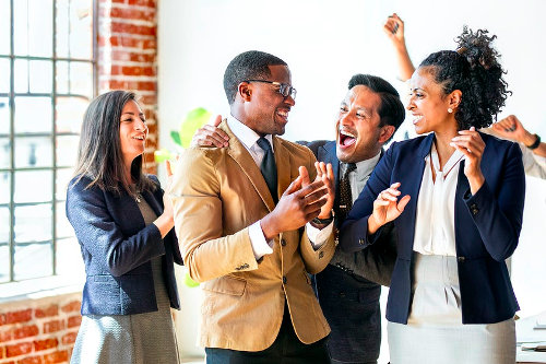 Promoted employee congratulated by his colleagues