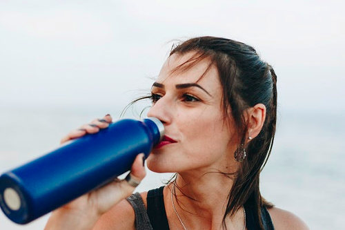 Healthy woman drinking water