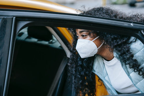 Riding taxi wearing face mask