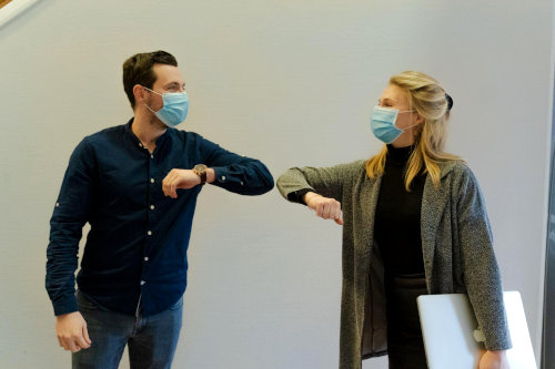 Employees elbow bump
