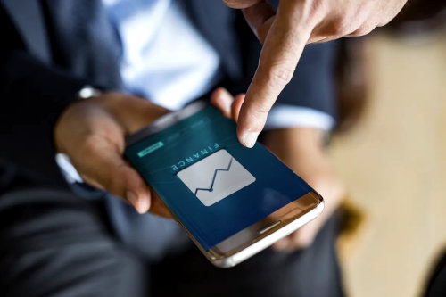 Businessman using investing app