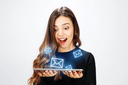 Young woman receiving emails on tablet PC