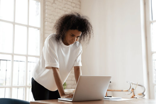 Young woman writing emails while working from home.